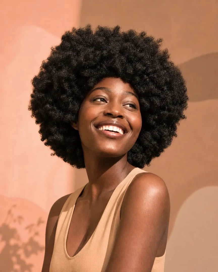 Woman rinsing textured hair